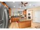 Open concept kitchen with stainless steel appliances, an island, and easy access to the living areas of the home at 7454 Sw 101St Ave, Ocala, FL 34481