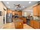 Well-lit kitchen with stainless steel appliances, central island, ample cabinets and countertop space, and light wood flooring at 7454 Sw 101St Ave, Ocala, FL 34481