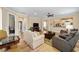 Spacious and comfortable living room featuring wood floors, a ceiling fan, and natural light at 7454 Sw 101St Ave, Ocala, FL 34481