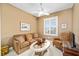 A cozy sitting room features neutral walls, plantation shutters, and comfortable seating, ideal for relaxation at 7454 Sw 101St Ave, Ocala, FL 34481