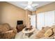 Cozy sitting room with a soft couch, armchair, and a decorative coffee table at 7454 Sw 101St Ave, Ocala, FL 34481