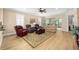 Spacious living room with wood floors, comfortable seating, and sliding doors to the lanai at 7454 Sw 101St Ave, Ocala, FL 34481