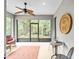 A relaxing screened-in lanai with a ceiling fan offers tranquil views of the backyard at 7454 Sw 101St Ave, Ocala, FL 34481