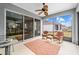 Relaxing screened patio with ceiling fan, wicker rocking chairs and view of the backyard at 7454 Sw 101St Ave, Ocala, FL 34481