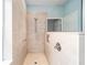 This renovated shower features a glass partition, modern fixtures, built-in niche, and neutral tile for a spa-like experience at 7454 Sw 101St Ave, Ocala, FL 34481