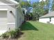 Backyard view featuring a well-maintained lawn and neighboring properties in a wooded setting at 80 Hickory Course Loop, Ocala, FL 34472