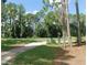 Scenic backyard with mature trees and well-maintained green space, perfect for outdoor activities at 80 Hickory Course Loop, Ocala, FL 34472