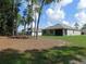 Expansive backyard featuring a lawn and tree coverage and neighboring homes at 80 Hickory Course Loop, Ocala, FL 34472