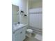 Bathroom with sink and cabinet, toilet, and shower with patterned curtain at 80 Hickory Course Loop, Ocala, FL 34472