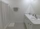Bright bathroom featuring double vanity with white cabinetry and shower with white curtain at 80 Hickory Course Loop, Ocala, FL 34472