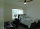 Bedroom with desk and chair, featuring a cozy bed and a window for natural light at 80 Hickory Course Loop, Ocala, FL 34472