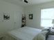 Neutral bedroom with a bed, a ceiling fan, and natural light from a window with white blinds at 80 Hickory Course Loop, Ocala, FL 34472