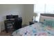 Bedroom with desk and chair, featuring a cozy bed and a window for natural light at 80 Hickory Course Loop, Ocala, FL 34472