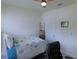 Cozy bedroom with a desk, a ceiling fan, and natural light from a window with white blinds at 80 Hickory Course Loop, Ocala, FL 34472