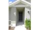 Close-up of the front door featuring clean lines and modern hardware at 80 Hickory Course Loop, Ocala, FL 34472