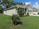 Home exterior displaying a well-kept lawn and landscaping, and an attached two-car garage at 80 Hickory Course Loop, Ocala, FL 34472