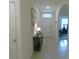 Open hallway featuring tile floors and natural light, leading to a study at 80 Hickory Course Loop, Ocala, FL 34472