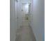 Hallway leading to a bathroom with tile flooring, a vanity, and good lighting at 80 Hickory Course Loop, Ocala, FL 34472