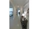 Inviting hallway with tile floors, showcasing the home's open floor plan and access to bedrooms and living areas at 80 Hickory Course Loop, Ocala, FL 34472