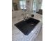 Kitchen island's sink with modern faucet, granite countertop, and stainless steel accents at 80 Hickory Course Loop, Ocala, FL 34472