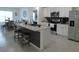 Modern kitchen with a granite countertop island, stainless steel appliances, and a stylish backsplash at 80 Hickory Course Loop, Ocala, FL 34472
