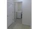 White laundry room with a washing machine visible through an open door at 80 Hickory Course Loop, Ocala, FL 34472