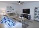 Comfortable living room featuring stylish furnishings, a large television, and ample space for relaxation at 80 Hickory Course Loop, Ocala, FL 34472