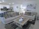 Inviting living room showcasing a modern decor with plush sofas and an open layout leading to the kitchen at 80 Hickory Course Loop, Ocala, FL 34472