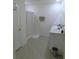Bright bathroom featuring double sinks, white cabinets, and a shower with a clear glass door at 80 Hickory Course Loop, Ocala, FL 34472