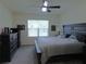 Comfortable main bedroom with a large window, fan, and classic dresser furniture at 80 Hickory Course Loop, Ocala, FL 34472