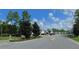 Welcoming neighborhood entrance with landscaped greenery, street lamps, and clear signage for a peaceful community setting at 80 Hickory Course Loop, Ocala, FL 34472