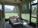 Cozy screened porch with seating and view of the home's backyard at 80 Hickory Course Loop, Ocala, FL 34472
