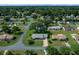 An aerial view of a well-maintained home with green lawns and mature trees in a quiet neighborhood at 8461 Sw 109Th St, Ocala, FL 34481