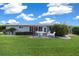 Spacious backyard with well-maintained lawn and patio area with outdoor seating at 8461 Sw 109Th St, Ocala, FL 34481