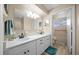 Bright bathroom featuring double sinks, white cabinets, and a combined tub and shower at 8461 Sw 109Th St, Ocala, FL 34481