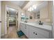 Bathroom with dual sinks, modern fixtures, and wood-look flooring at 8461 Sw 109Th St, Ocala, FL 34481