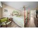 Charming bedroom featuring a four-poster bed, natural light, and cozy seating at 8461 Sw 109Th St, Ocala, FL 34481