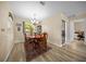 Cozy dining room featuring wood floors, a chandelier, and access to both the kitchen and a sunroom at 8461 Sw 109Th St, Ocala, FL 34481