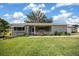 Charming single-story home with a well-manicured lawn, complemented by lush landscaping and a welcoming front porch at 8461 Sw 109Th St, Ocala, FL 34481