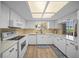 Bright kitchen featuring white cabinets, modern appliances, and a window with a view at 8461 Sw 109Th St, Ocala, FL 34481