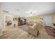 Bright living room featuring hardwood floors, ceiling fan, front door and access to an office at 8461 Sw 109Th St, Ocala, FL 34481
