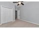 Neutral bedroom featuring a ceiling fan and large closet offering ample storage at 8775 Sw 192 Ct, Dunnellon, FL 34432