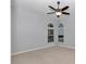 Bedroom with neutral carpet, ceiling fan, and natural light from two windows at 8775 Sw 192 Ct, Dunnellon, FL 34432