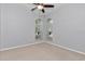 Bright bedroom with neutral walls and arched windows, offering a serene space at 8775 Sw 192 Ct, Dunnellon, FL 34432