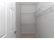 Walk-in closet with ample shelving for optimal storage and organization at 8775 Sw 192 Ct, Dunnellon, FL 34432