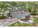 Charming single-story home featuring an attached two-car garage, manicured lawn and mature trees at 8775 Sw 192 Ct, Dunnellon, FL 34432