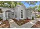 Charming home exterior with arched doorway, landscaped garden and sidewalk appeal at 8775 Sw 192 Ct, Dunnellon, FL 34432