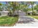 Well maintained single-story home featuring an attached two-car garage, mature trees and a manicured lawn at 8775 Sw 192 Ct, Dunnellon, FL 34432