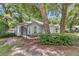 Charming home featuring mature trees, tidy landscaping, arched window and a welcoming front entryway at 8775 Sw 192 Ct, Dunnellon, FL 34432
