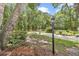 View of the front yard featuring lush landscaping and mature trees at 8775 Sw 192 Ct, Dunnellon, FL 34432